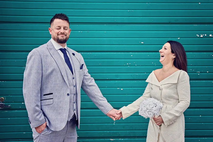 Couple holding hands at registry office ceremony in The Hive, Worcester Couple holding hands at registry office ceremony in The Hive, Worcester