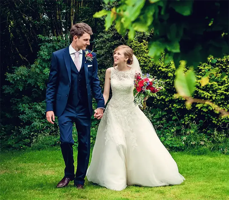Bride and groom walking through summer gardens Bride and groom walking through summer gardens